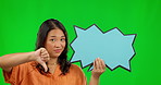 Thumbs down, social media and speech bubble with an asian woman on a green screen background. Poster, emoji and rejection with an unhappy female model in studio to dislike a post on chromakey mockup