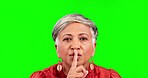 Secret, green screen and senior woman in a studio with a quiet or silence face expression. Gossip, portrait and mature female model with a finger on her lips gesture isolated by chroma key background