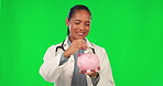 Piggy bank, cash and doctor on green screen for savings, future healthcare planning and health insurance. Save money, notes and financial loan of happy, medical and latino woman on studio background
