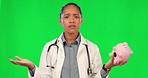 Confused, piggy bank and face of doctor on green screen with financial problem, debt and doubt in studio. Insurance, healthcare and portrait of woman on chromakey with finance, money or payment issue