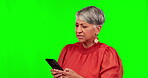 Annoyed, phone and confused with business woman on green screen for news, social media and networking. Anger, feedback and busy with senior employee on studio background for contact and online