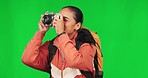 Woman, hiking and green screen with adventure and photography, trekking and taking picture on studio background. Mockup space, vacation and sightseeing with female photographer, camera and travel