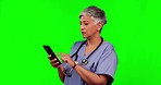 Nurse woman, phone and texting by green screen for search, confused or disappointed with scroll in mockup. Senior female medic, smartphone or typing for chat, medical research or unhappy with results
