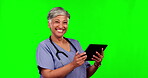 Nurse, face of woman and tablet on green screen in studio isolated on a background mockup. Medical professional, technology and portrait of senior surgeon laughing at comedy, funny meme or healthcare