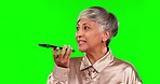 Phone, voice note and senior woman on green screen for conversation, chatting and discussion. Communication, recording speech and female person talking on smartphone for contact in chromakey studio