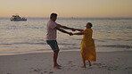 Love, couple dance at beach and happy together for romantic date. Summer vacation or holiday break, happiness or support and married people dancing for retirement or anniversary at the ocean