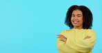 Smile, option and pointing with a black woman on a blue background in studio to decide on a selection. Portrait, decision and laughter with a happy young afro female person showing her choice