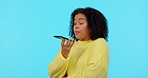 Speaker, phone call and woman with anger, stress and frustrated girl on a blue studio background. Angry, female person and model furious, smartphone and fighting with conflict and crisis with contact