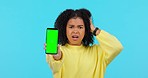 Woman, phone and angry in studio with error, glitch and green screen with mock up space by blue background. African student girl, smartphone and stress for slow internet, software update and broken