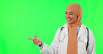 Muslim woman, face and doctor pointing on green screen in studio isolated on a background mockup. Portrait, arms crossed and confident medical professional with hand gesture for happy marketing space