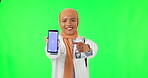 Muslim woman, doctor and pointing to phone on green screen for advertising against a studio background. Portrait of female medical or healthcare professional point to smartphone with tracking markers