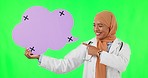 Muslim woman, doctor and point to speech bubble on green screen against a studio background. Portrait of female medical or healthcare professional pointing for social media, chat or message on mockup