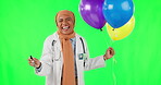 Party, woman and hijab with balloons green screen with happiness in medical care at hospital. Excited, female professional and muslim is happy with stethoscope for celebration at clinic with humour.