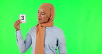 Education, teacher and an arab woman on green screen with cards in studio for a study lesson. Portrait, picture and school with a female educator teaching a lesson for child development on chromakey