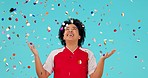 Celebration confetti, applause and woman excited for studio bonus, winning reward or prize giveaway. Success happiness, winner achievement and person clapping, celebrate or smile on blue background