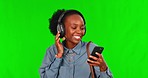 Music, phone and black woman dance on green screen in studio isolated on a background mockup. Radio, headphones and happy African person with mobile listening to audio, sound or podcast with energy.