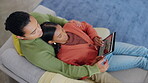 Tablet, holiday destination and a couple on a sofa in the living room of their home together from above. Love, vacation or technology with a man and woman browsing the internet while planning a trip