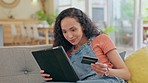 Home, payment and woman with a tablet, credit card and happiness with online shopping, transactions and finance. Female person, customer and girl on a couch, technology and ecommerce with savings