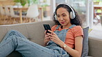 Headphones, phone and woman on sofa listening, audio streaming and dancing for mental health and break at home. Relax, couch and young person with gen z music, electronics and mobile in living room