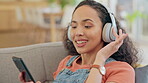 Woman, phone and headphones on couch listening, audio streaming and dancing for mental health and home break. Relax, sofa and young person with gen z music, electronics and mobile chat in living room