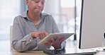 Technology, elderly woman with tablet and happy at her desk in a modern workplace office. Social networking or connectivity, online communication and senior female person type an email at workstation