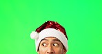 Man, face and Christmas hat by green screen, thinking and looking in holiday fashion, promotion or mockup space. Guy, headshot and xmas clothes for festive celebration, search and ideas by background