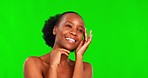 Black woman, face and beauty skincare on green screen for facial treatment against a studio background. Happy African female person touching skin with smile for smooth, glow or shine in dermatology