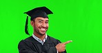 Pointing man, face and graduation on green screen in studio isolated on a background mockup. Portrait, graduate and happy Asian student with space for advertising, marketing or promo for university.