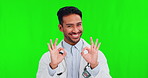 Healthcare ok, face and an Asian man on a green screen for medical trust, progress and motivation. Happy, pride and portrait of a doctor with perfect hand gesture isolated on a studio background