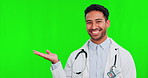 Healthcare, green screen and presentation with a doctor man on a studio background to recommend a product. Portrait, medical and palm with a happy young male medicine professional on chromakey mockup