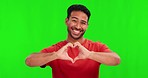 Love, face and a man with heart hands on a green screen for care, romance and valentines day. Smile, pride and portrait of an Asian person with a support emoji gesture isolated on a studio background