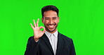 Business man, smile and ok sign on green screen for good review, feedback and motivation. Portrait of professional asian person on studio background for with hand sign, okay emoji or agreement