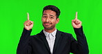 Pointing, face and a businessman on a green screen with a decision, choice or option for work. Happy, presentation and portrait of Asian employee with gesture to mockup isolated on studio background