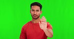 Green screen, hand and stop by man face in studio with no, reject or warning, sign language and boundaries on mockup background. Palm, emoji and portrait of asian male with ban, threat or protest