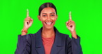 Happy woman, pointing up and green screen in celebration for discount sale or advertising against a studio background. Portrait of female person with smile and show for news notification or marketing