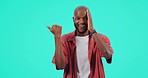 Face, pointing and black man with surprise, opportunity and presentation on a blue studio background. Portrait, male person and model with hand, mockup space and giveaway with information and choice