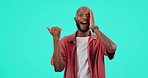 Face, pointing and black man with promotion, surprise and winning against a blue studio background. Portrait, male person and model with hand, mockup space and announcement with giveaway and shocked