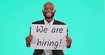 Business man, billboard and face in studio for human resources, opportunity and smile by blue background. African businessman, we are hiring and hr job for talent, startup and poster in portrait