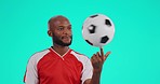 Soccer ball, balance and face of black man in studio for fitness, sports and training motivation on blue background. Football, hand and portrait of African male coach smile for match practice routine