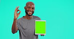 Okay sign, black man with tablet and against a blue background for advertising. Marketing or promotion, product placement or tech and African male person pose for mockup space against a chroma key