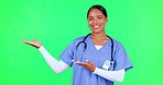 Marketing, presentation and nurse in a studio with green screen for a promotion or advertising. Healthcare, happy and portrait of a female doctor with a pointing hand gesture by chroma key background