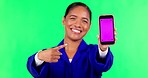 Advertising phone, pointing and woman on green screen for website, internet and mobile app with tracking markers. Hand sing, show and portrait of female person on smartphone for news and social media