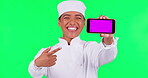 Woman face, chef and phone on green screen for restaurant promotion, online menu or presentation. Mobile app, mockup and food expert, cook or person pointing on tracking markers and studio background