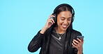 Woman, dancing to music with smartphone and headphones, listening to playlist and energy on blue background. Young female person, audio streaming and radio, happiness and gen z with mockup space