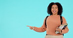 Pointing, choice and portrait of student woman showing college or university option isolated in a studio blue background. Smile, happy and young woman or person with promo, deal or announcement