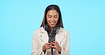 Woman, typing on smartphone and communication, social media and smile at meme online on blue background. Headphones, text message and young female person with chat, internet search and mockup space