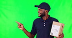 Green screen, black man with box and pointing to list, information or presentation of menu, checklist or show delivery timeline. Courier, shipping and portrait of worker with order, package or info 