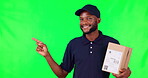 Happy black man, box and pointing on green screen in list, presentation or info against a studio background. Portrait of African male person, delivery or courier guy show step or menu on mockup space