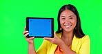 Tablet, advertising or branding and a woman on green screen background in studio holding a display with tracking markers. Portrait, marketing website and a happy young asian female holding chromakey