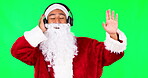 Music, dance and santa man on green screen in studio isolated on a background. Christmas headphones, claus and person listen, streaming or enjoy radio, audio or podcast sound for holiday celebration.